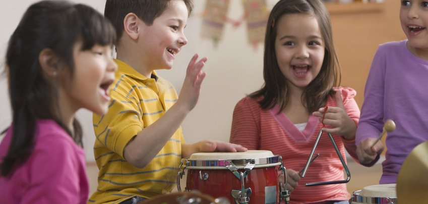 Students playing musical instruments in classroom